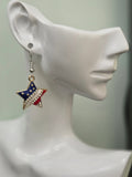 Handmade American flag star earring displayed on a white mannequin ear, featuring red, white, and blue enamel with a diagonal rhinestone band and gold-tone setting