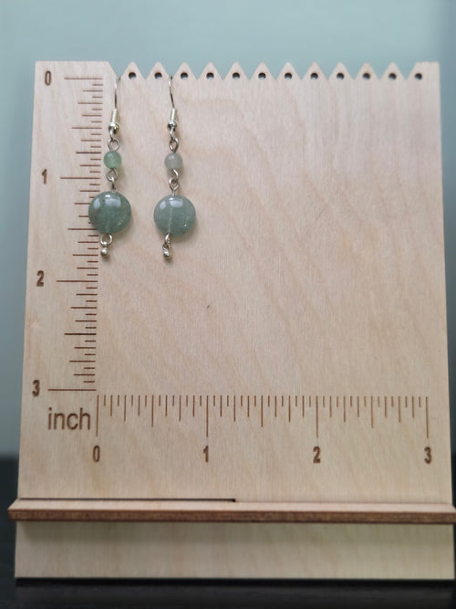 Aventurine dangle earrings displayed on a wooden earring stand with ruler showing approximately 1.75 inch length