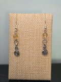 Close-up of silver-tone spiral charm earrings with faceted citrine beads