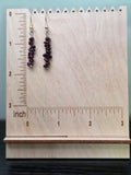 Genuine garnet chip bead stack earrings in deep wine red, close-up on wood grain surface