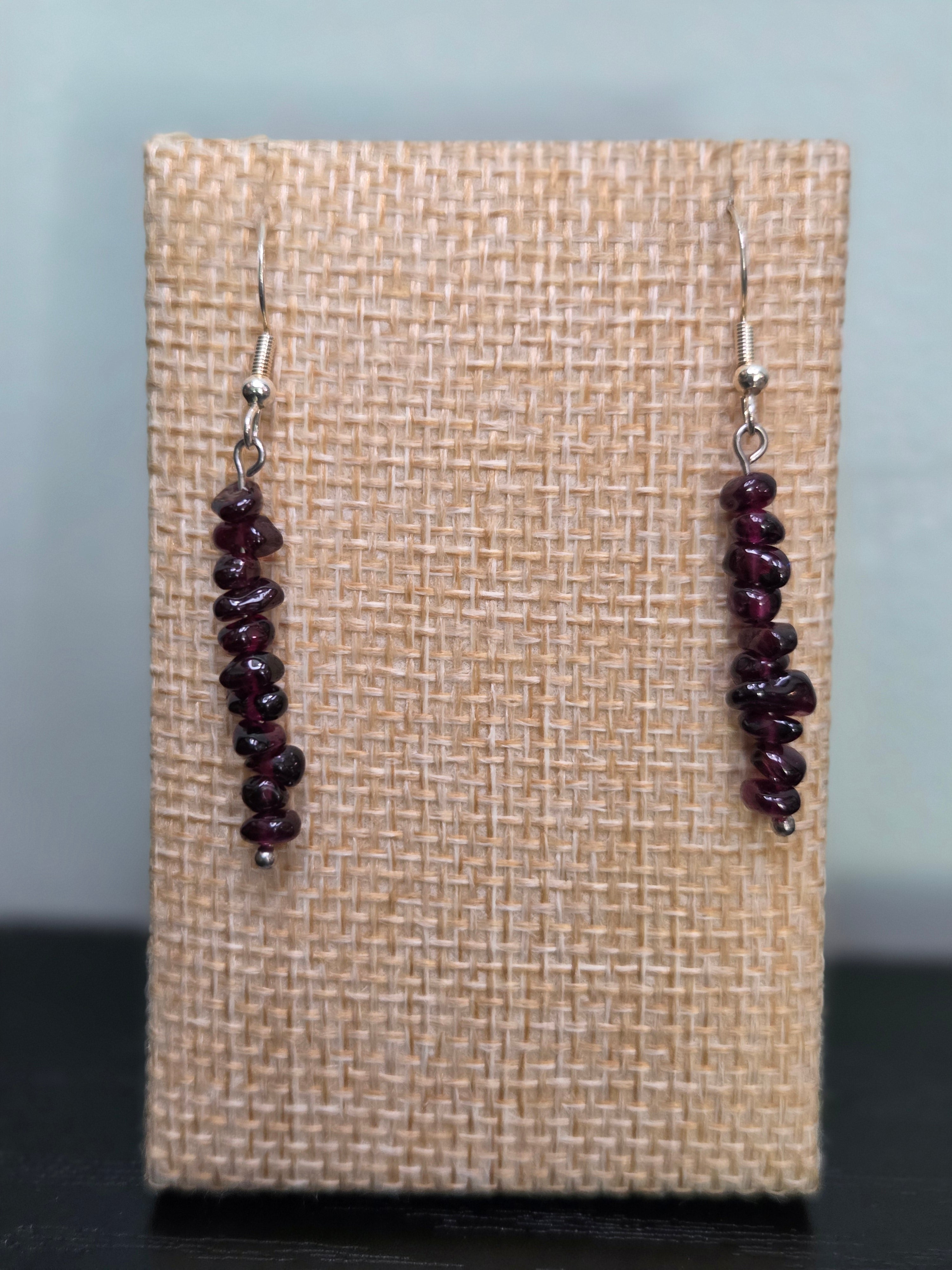 Garnet chip stack drop earrings on woven fabric display, showing deep burgundy color and silver-tone ear wires