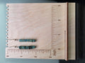 Hemalyke square stack drop earrings displayed on a wooden earring stand with ruler showing approximately 1.75 inch length
