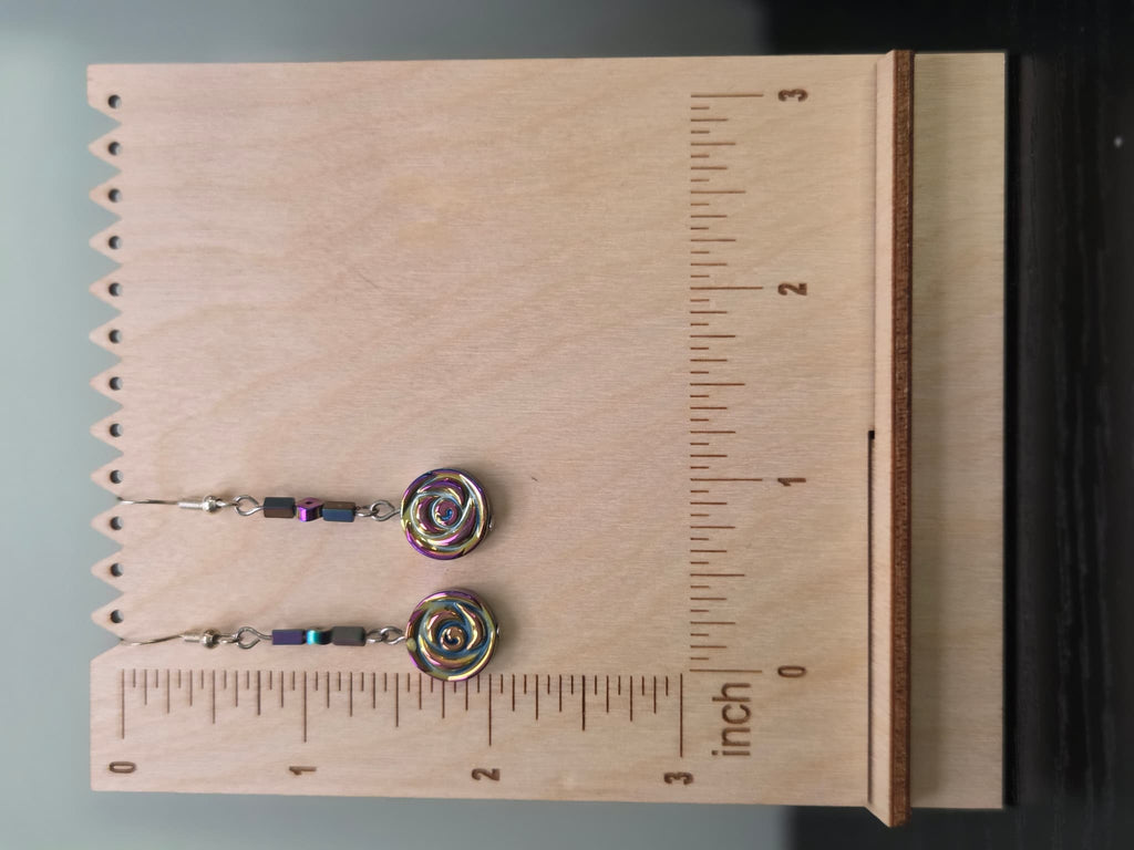 Hemalyke rose drop earrings displayed on a wooden earring stand with ruler showing approximately 2 inch length