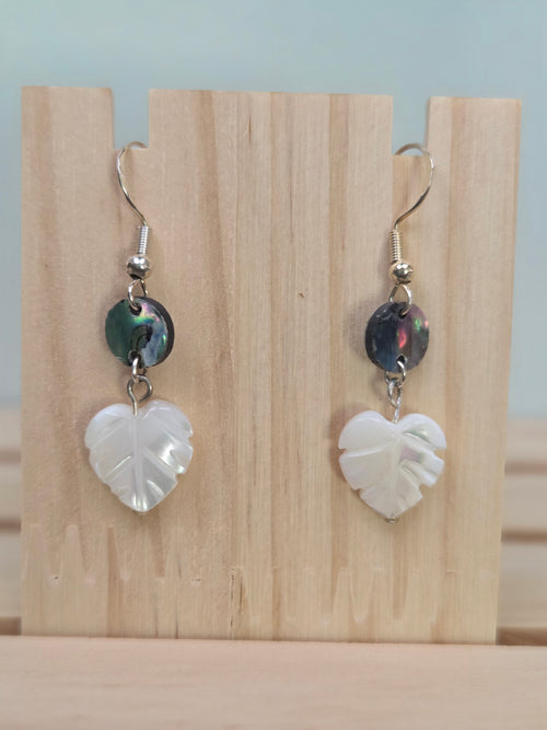 Close-up of abalone shell disc and carved mother-of-pearl heart-shaped leaf earrings