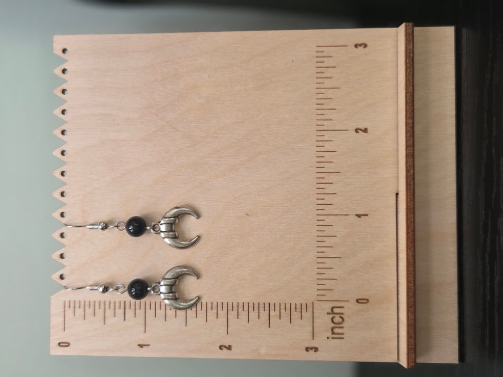 Pair of banded crescent moon onyx earrings shown beside a ruler, approximately 1.75 inches long