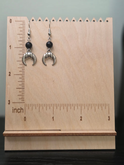 Pair of banded crescent moon onyx earrings shown beside a ruler, approximately 1.75 inches long