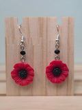 Red acrylic poppy flower dangle earrings with black glass bead accent and silver fish hook ear wires
