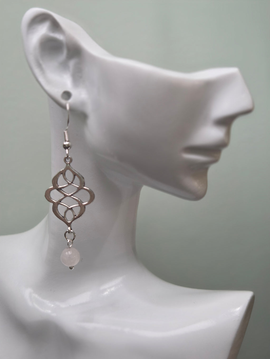 Rose quartz swirl knot dangle earrings, silver-tone connector with pale pink rose quartz bead