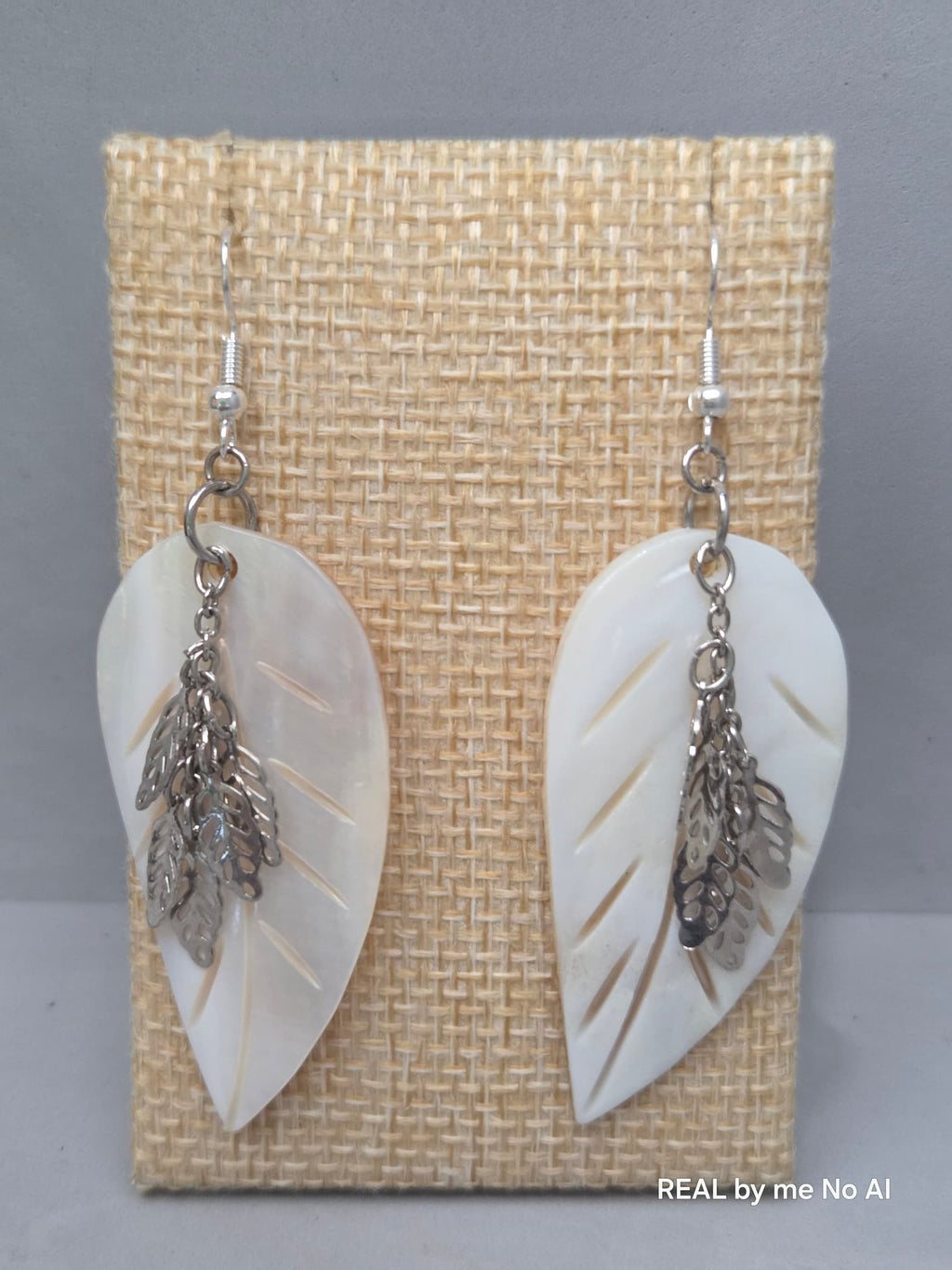 Cascading silver-tone leaf charms on mother of pearl dangle earrings
