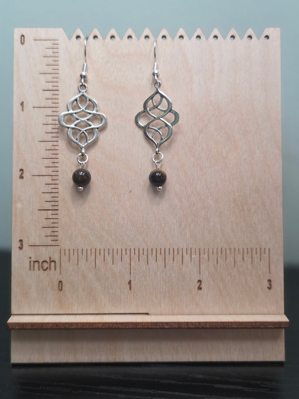 Tiger's eye swirl knot dangle earrings, silver-tone connector with amber and brown tiger's eye bead