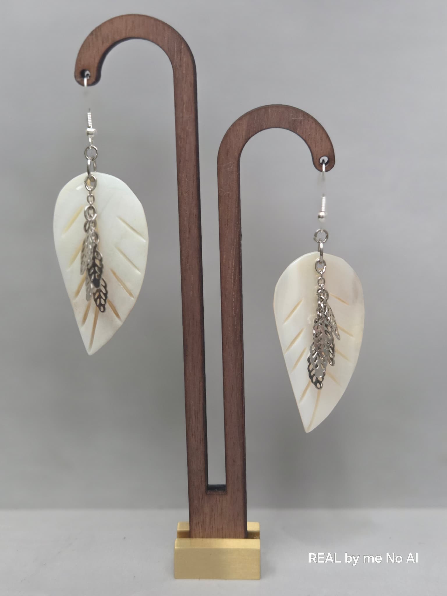Mother of pearl leaf earrings shown with silver-tone ear wires