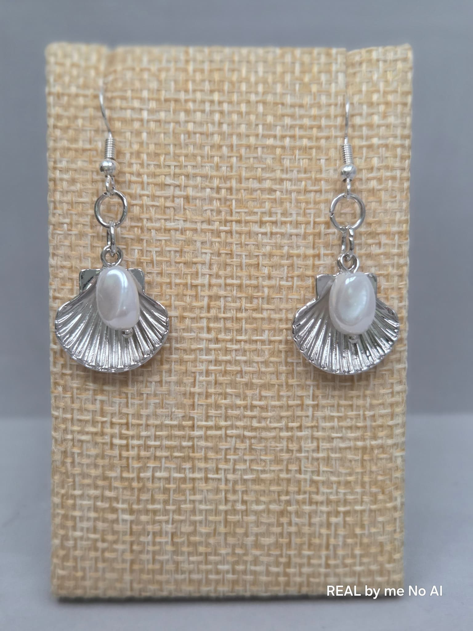 Silver shell and pearl earrings shown with silver-tone ear wires