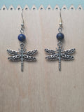 Dragonfly and sodalite drop earrings with antiqued silver-tone filigree dragonfly charm, displayed on a wooden earring stand with ruler showing approximately 2 inch length