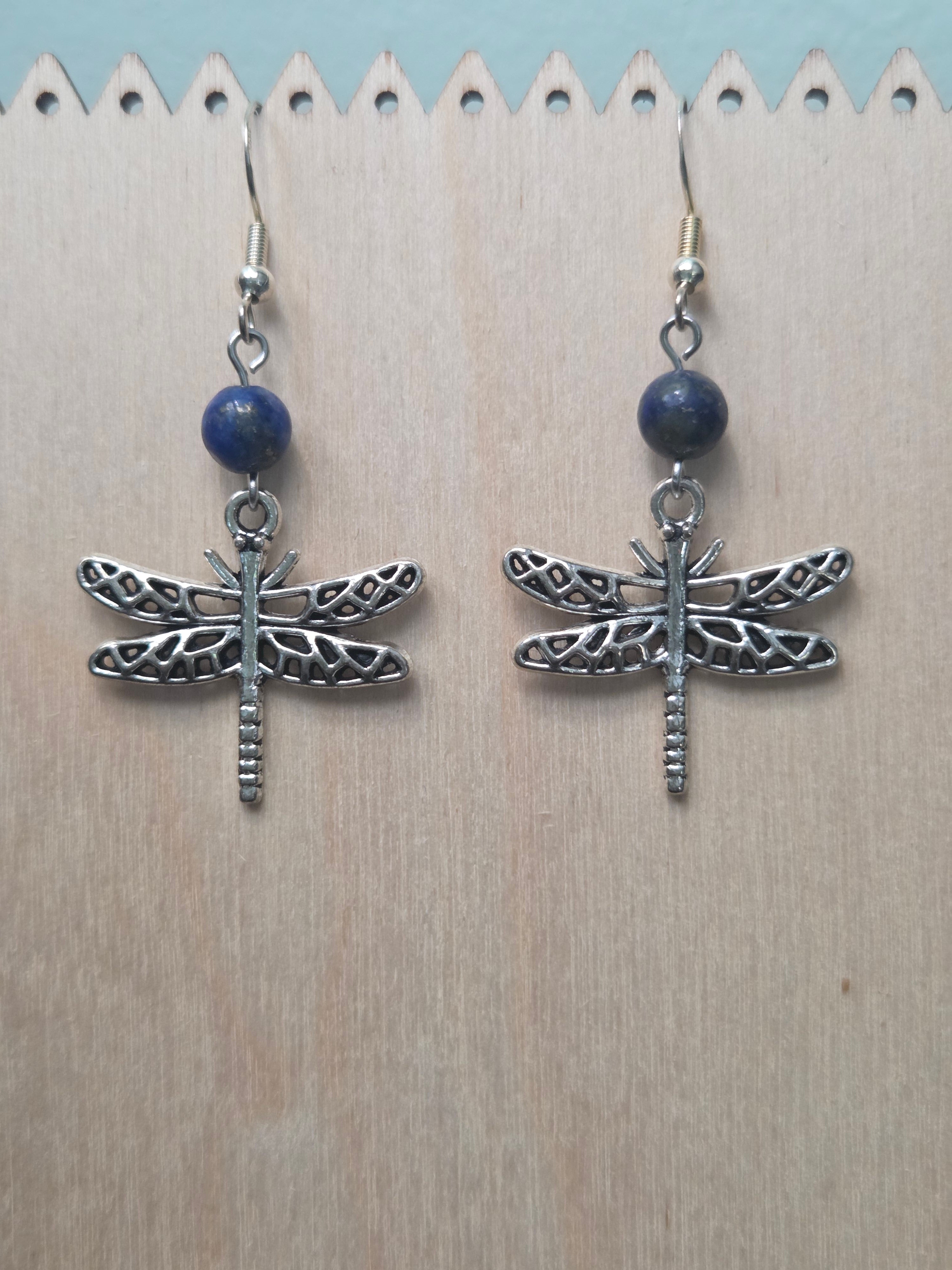 Dragonfly and sodalite drop earrings with antiqued silver-tone filigree dragonfly charm, displayed on a wooden earring stand with ruler showing approximately 2 inch length