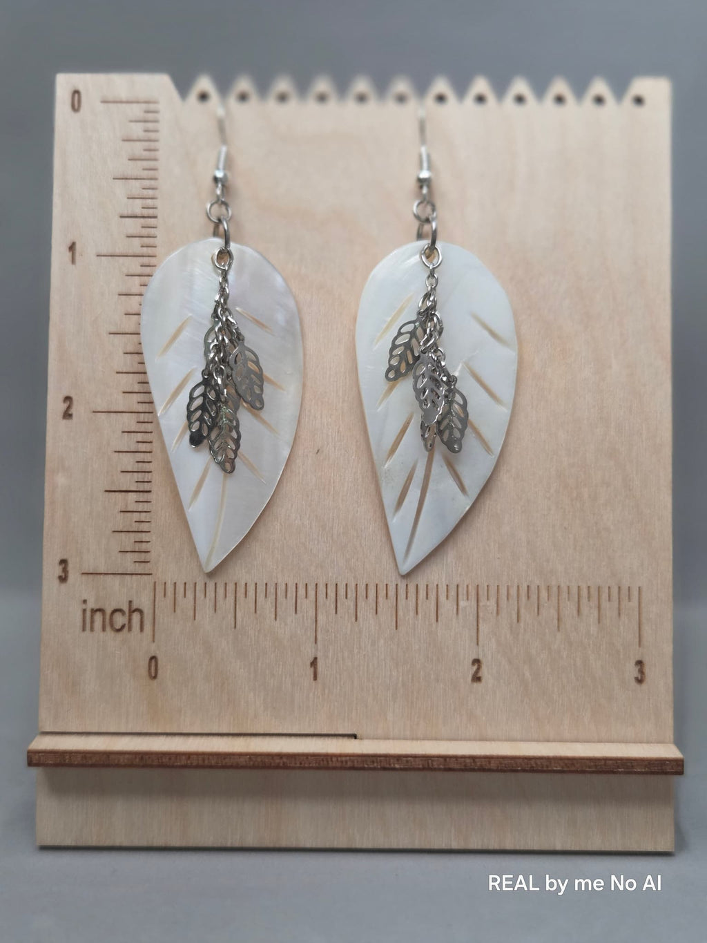 Close-up of genuine mother of pearl leaf charm showing natural iridescence