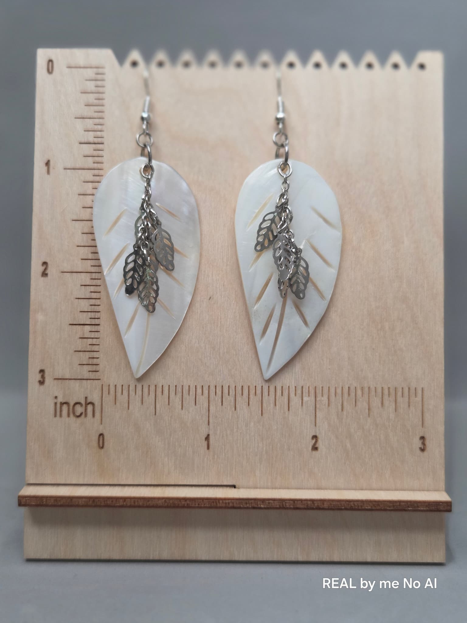 Close-up of genuine mother of pearl leaf charm showing natural iridescence